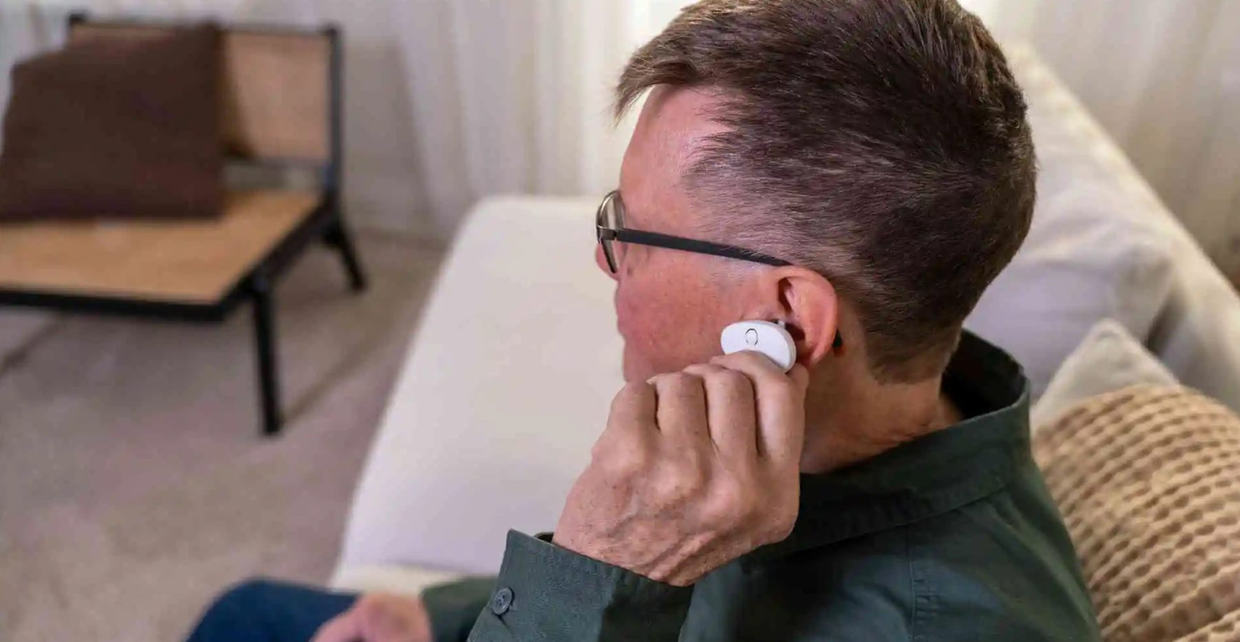 Man clipping EVANES onto his left ear