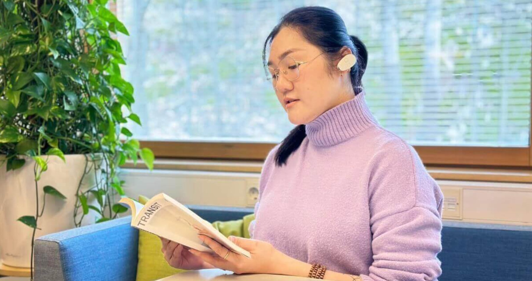 Woman sitting with a book and wearing EVANES