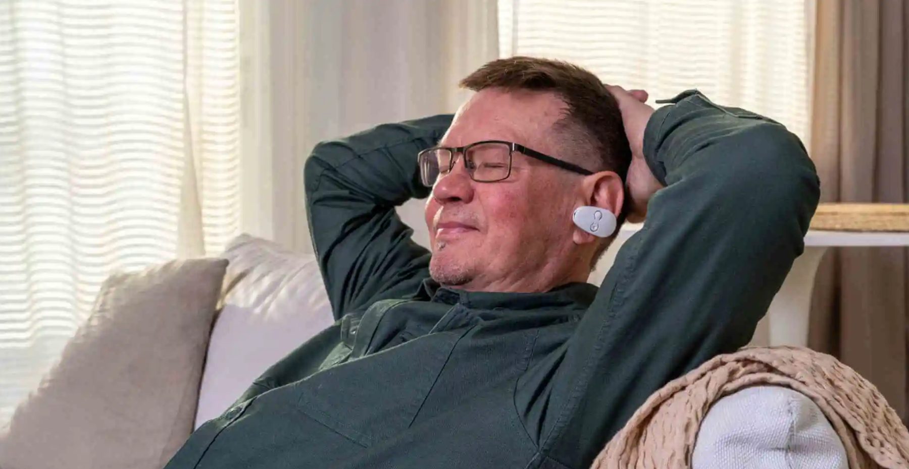 Man relaxing on a sofa during an EVANES session